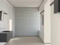 Bagno moderno con lavabo sospeso e parete con motivo geometrico. I **mutina rivestimenti** creano un ambiente di design.