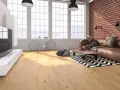 Soggiorno moderno con parquet effetto legno chiaro, divano in pelle, bici e mattoni a vista. Scopri i laminato Skema prezzi.