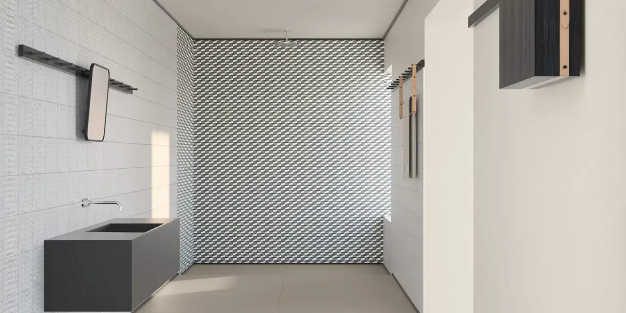 Bagno moderno con lavabo sospeso e parete con motivo geometrico. I **mutina rivestimenti** creano un ambiente di design.