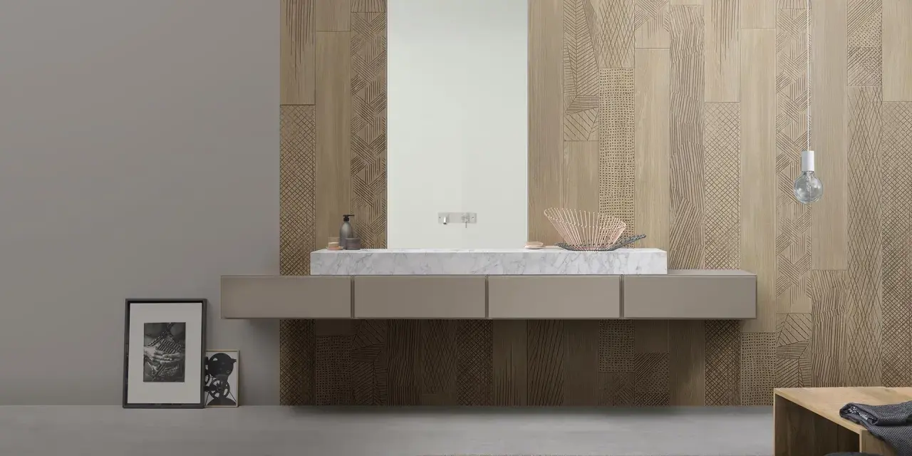 Bagno moderno con lavabo in marmo e specchio, su una parete rivestita con un elegante parquet a parete decorato con motivi geometrici.