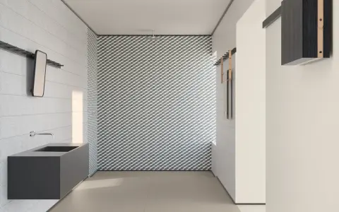 Bagno moderno con lavabo sospeso e parete con motivo geometrico. I **mutina rivestimenti** creano un ambiente di design.