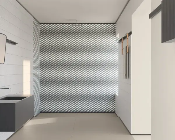 Bagno moderno con lavabo sospeso e parete con motivo geometrico. I **mutina rivestimenti** creano un ambiente di design.