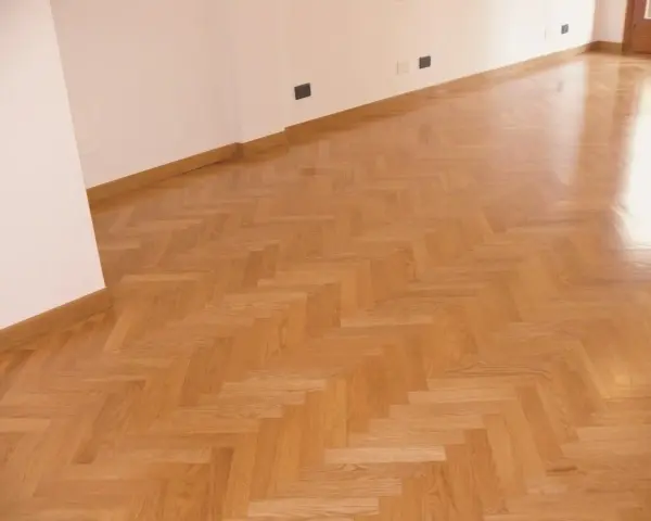 Parquet verniciato ad acqua con finitura lucida, posato a spina di pesce. Ottime opinioni per questo pavimento in legno.