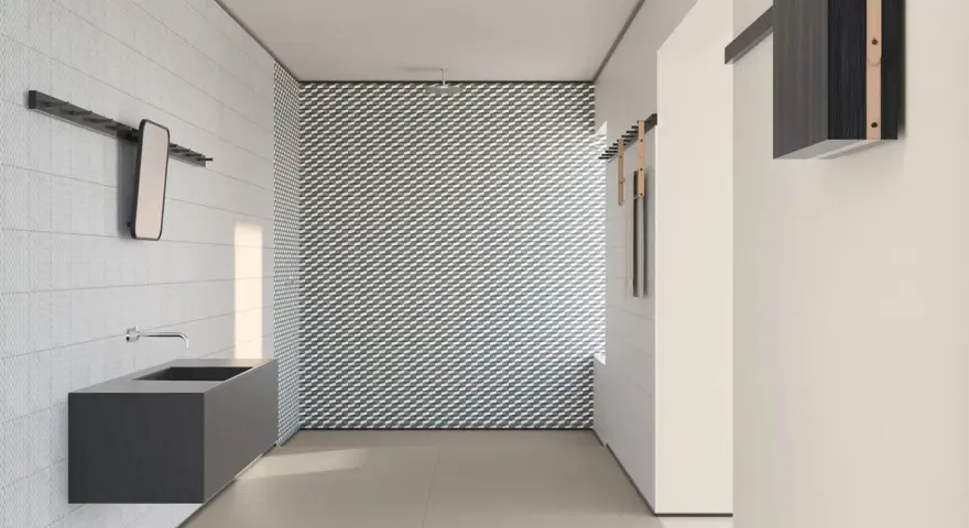 Bagno moderno con lavabo sospeso e parete con motivo geometrico. I **mutina rivestimenti** creano un ambiente di design.