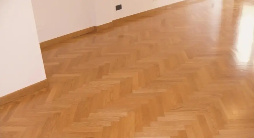 Parquet verniciato ad acqua con finitura lucida, posato a spina di pesce. Ottime opinioni per questo pavimento in legno.