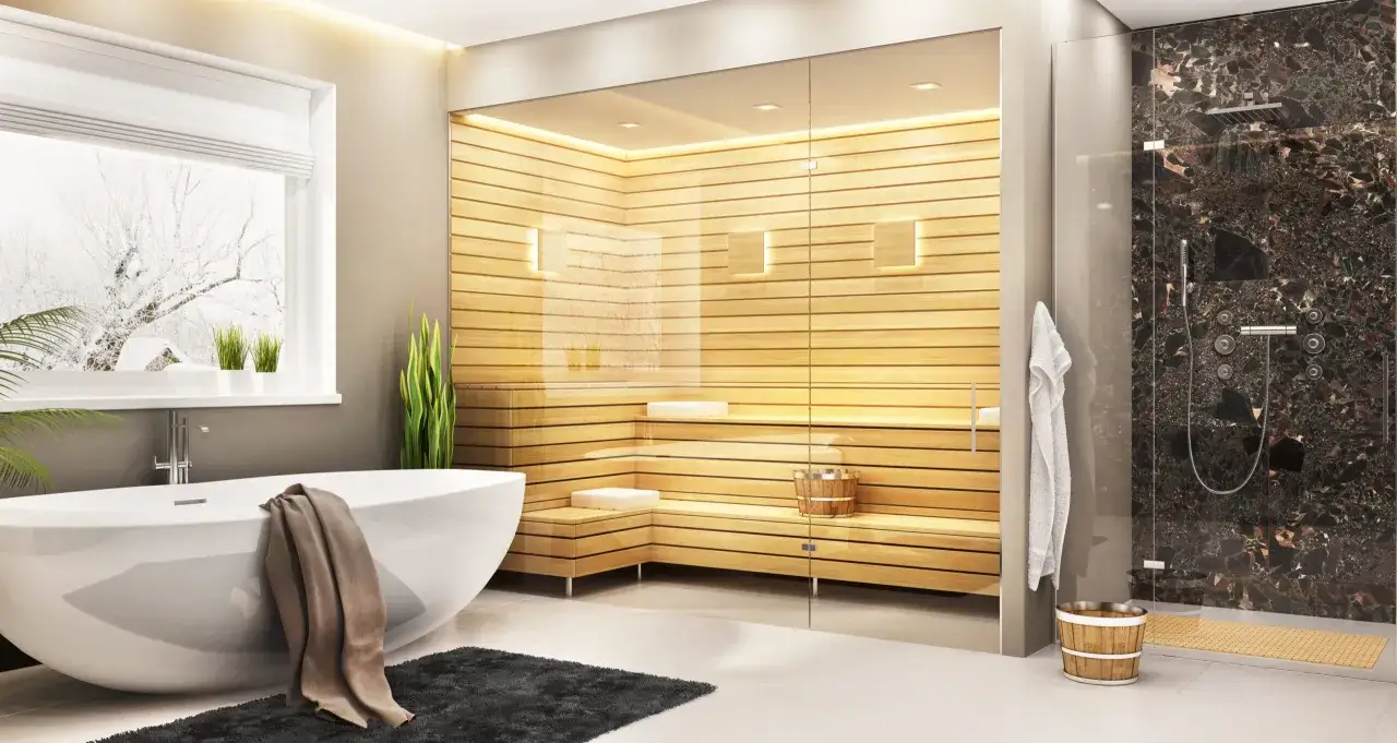 Bagno moderno con vasca, sauna in legno e doccia con finiture in marmo. Fuori nevica, ma dentro si pu&ograve; scegliere tra il calore della sauna o una doccia gelata.