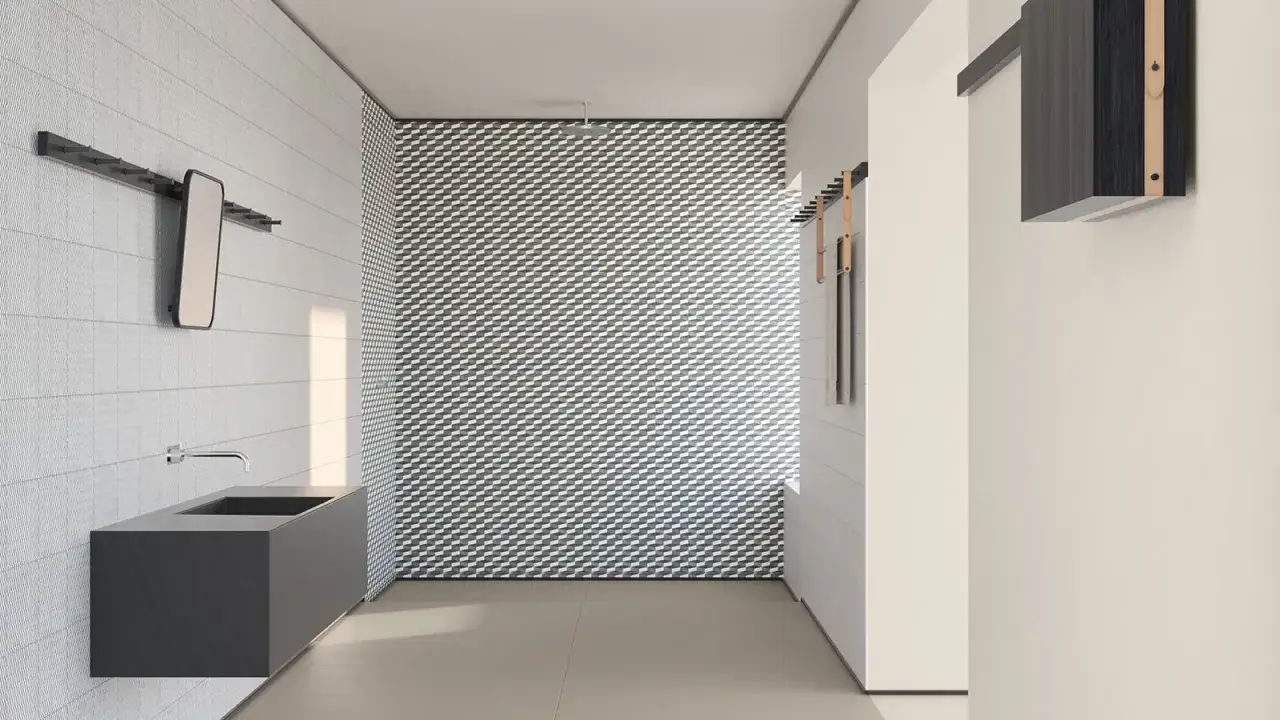Bagno moderno con lavabo sospeso e parete con motivo geometrico. I mutina rivestimenti creano un effetto visivo unico.